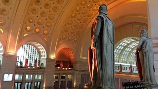 View of the gilded c offered ceiling in Union Station from the balcony behind the statues.