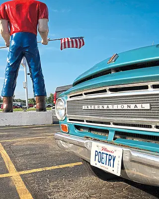 A car and Paul Bunyan statue on Route 66.